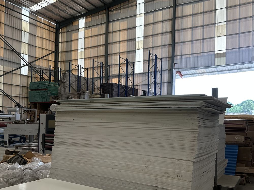 Stack of plain PVC boards in a warehouse