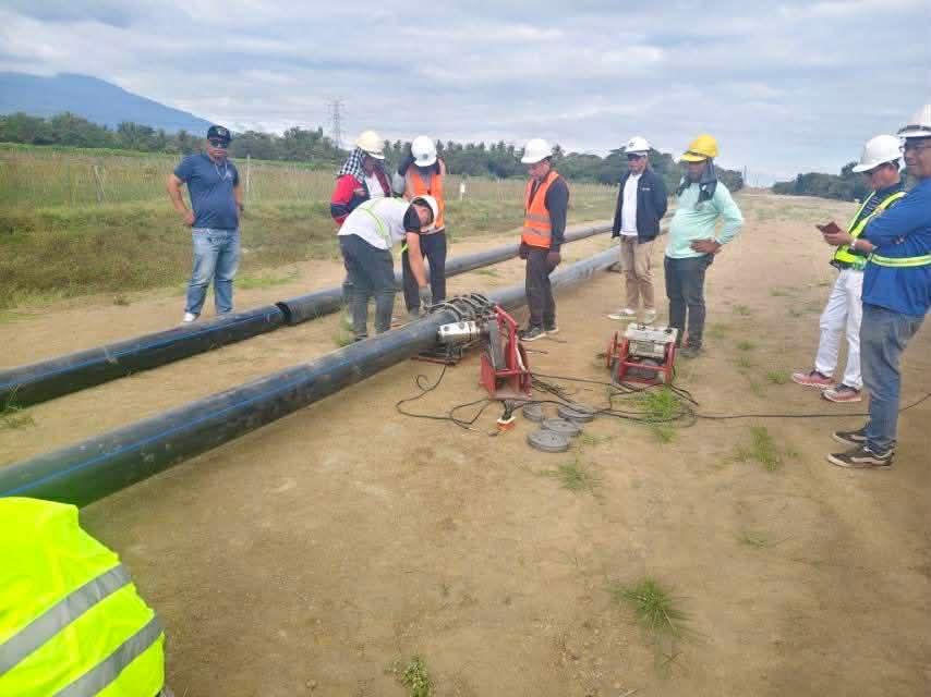 HDPE solid pipe being installed by a work crew